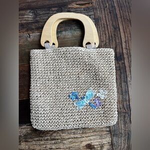 Small woven clutch with wooden handle